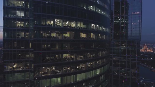 A night drone Aerial shot of skyscrapers of  business centre city, 4K Ultra HD real time video. Urban scene of consulting company office. Camera moving around building. Moscow skyline