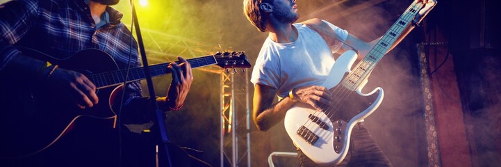 Male guitarists performing at nightclub