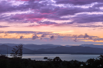 Beautiful sky over a dam at sunrise with brilliant colors