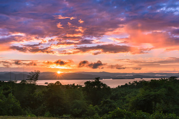 Beautiful sky over a dam at sunrise with brilliant colors