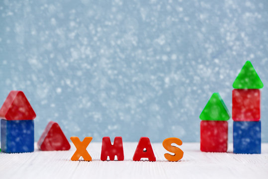 Xmas colorful wooden text on white wooden desk with Christmas decorations, Merry Christmas and happy new year concept.