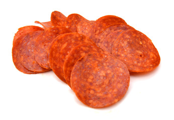 Slices of pepperoni on white background  - obrazy, fototapety, plakaty