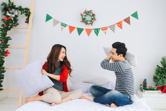 Christmas. Asian Couple at home celebrating New Year.