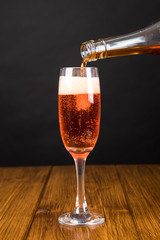 red champagne glass on a wooden background