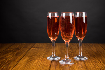 red champagne glass on a wooden background