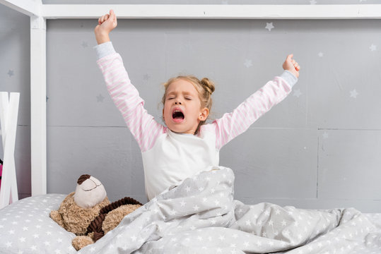 Adorable Little Kid Yawning And Stretching While Waking Up