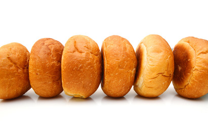 Freshly baked loaf of bread, hot and steaming on white 