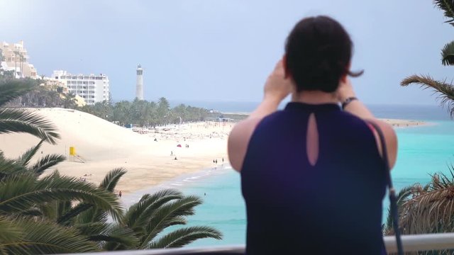 High quality video of woman taking picture at view at morro jable beach in fuerteventura in real 1080p slow motion 120fps