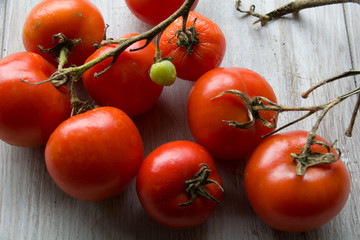 Tomatoes on white wood.