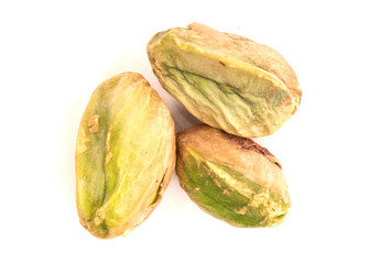 Macro view of three pieces of pistachio nut