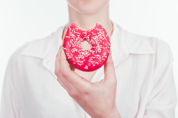 cropped shot of woman holding bitten glazed doughnut