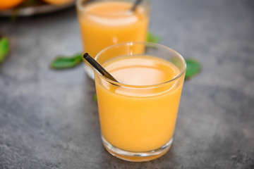 Glasses of fresh orange juice on table