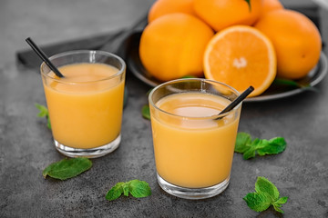 Glasses of fresh orange juice on table