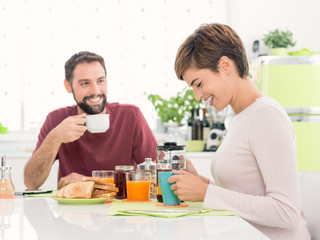 Young loving couple having breakfast at home