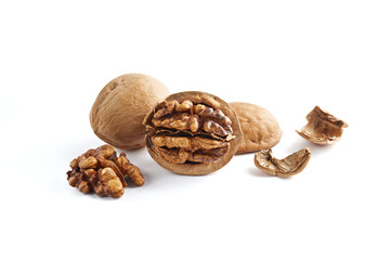 Walnuts and walnuts kernels with shell crumbles isolated on white background.