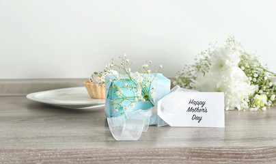 Gift box with flowers for Mother's day on table