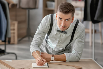 Young tailor working in atelier