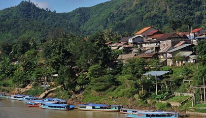 Slow boats blue long in little town in Laos