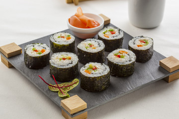 Futomaki served on a slate tray with ginger.