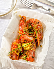 Fresh prawns cooked in papillote served in paper.