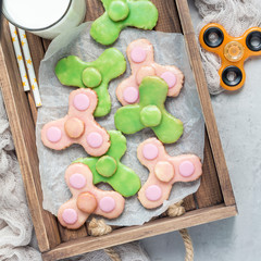 Homemade shortbread cookies made in trendy spinner toy form, top view, square format