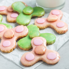 Homemade shortbread cookies made in trendy spinner toy form and a glass of milk, square