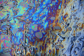 Abstract colorful rainbow oil slick on water background