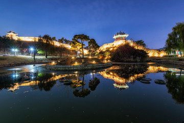 Reflection of Suwon Hwaseong fortres at night in Suwon.Korea