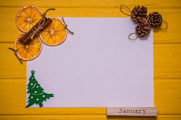 White blank paper with christmas tree, cinnamon, orange slices, bumps and word 