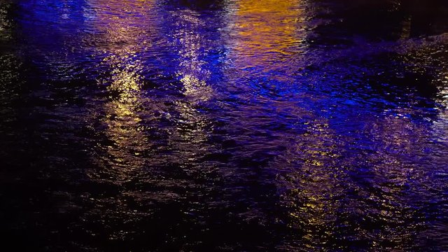 Reflections of shadows on the river passing through the bridge