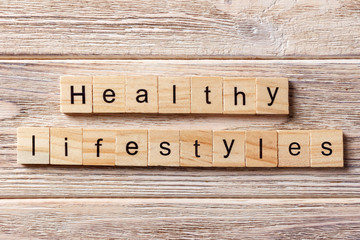 Healthy lifestyle word written on wood block. Healthy lifestyle text on table, concept