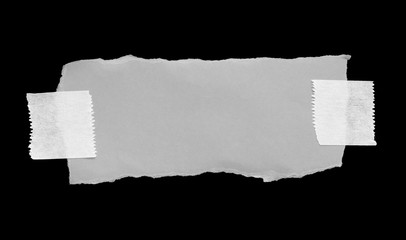 ripped note paper with adhesive tape on a black background