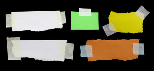 ripped note paper with adhesive tape on a black background