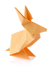 Orange easter bunny of origami, isolated on white background.