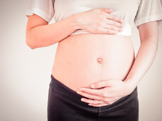 pregnant woman holds her hands on her belly.maternity concept.Belly of pregnant woman with hands.