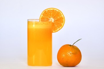 Natural Orange juice filled in a glass with a slice of orange 