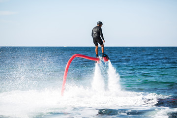 Silhouette of a fly board rider at sea