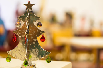 Golden Christmas tree decorations on the table.