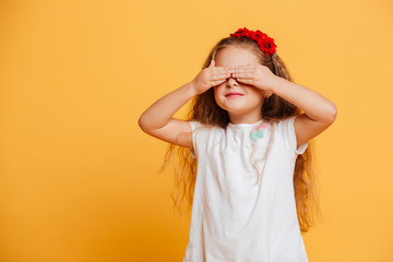 Little girl child standing isolated over yellow