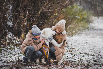 Children walking in the autumn Park with his beloved dog 9870.