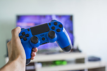 Male hand holding a game joystick controller, front view © phaelshoots