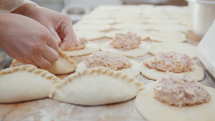 Cooks is making bakery products by hands
