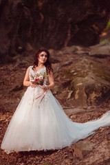 Fototapeta premium The charming bride stands on the ground