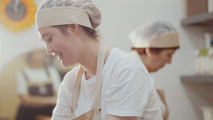 Smiling women cooks is working on the kitchen