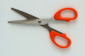 Paper scissors, orange handle on white background