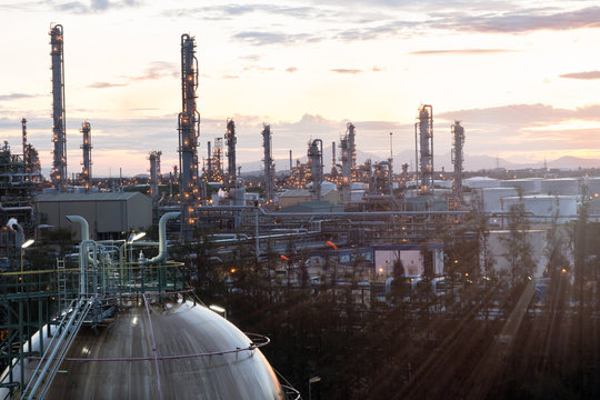 Gas storage spheres tank in oil refinery plant at sunrise