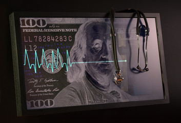 Fading cardiogram and stethoscope against the background of the US dollar