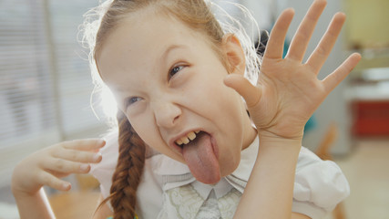 Little girl ape, showing tongue piglet nose and tongue © KONSTANTIN SHISHKIN