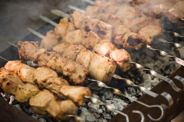 Marinated shashlik preparing on a barbecue grill over charcoal. Shashlik or Shish kebab popular in Eastern Europe. Shashlyk (skewered meat) was originally made of lamb. Roast Beef Kebabs On BBQ Grill.