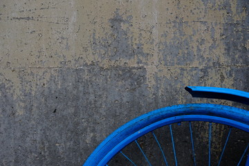 blue bicycle tire in front of a wall